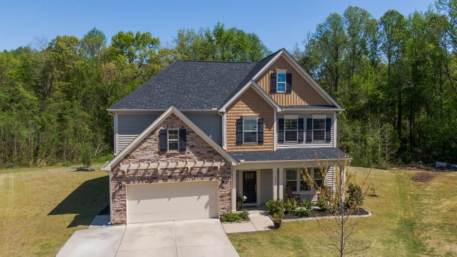 Residential house with new roof and siding installation